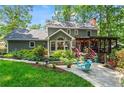 Secluded backyard oasis featuring a patio, lush greenery, and a covered porch at 4686 Buckskin Sw Trl, Lilburn, GA 30047