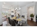 Open concept dining room with modern chandelier, hardwood floors and lots of natural light at 2161 Colvin Ct, Atlanta, GA 30318