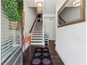 Bright foyer with hardwood floors, stairs, a console table, and a large mirror at 2161 Colvin Ct, Atlanta, GA 30318