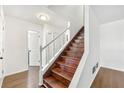 Bright foyer featuring hardwood stairs, white walls and trim at 534 Woodcrest Manor Dr, Stone Mountain, GA 30083