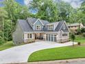 Beautifully designed two-story home with lush landscaping, featuring a spacious driveway and a modern color palette at 331 Terrell Sw Dr, Marietta, GA 30064