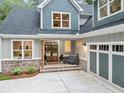 Inviting front porch with a cozy seating area, featuring double doors and brick accents that add to the home's charm at 331 Terrell Sw Dr, Marietta, GA 30064