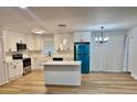 Bright kitchen with white cabinets, stainless steel appliances, and a large kitchen island at 559 Allgood Rd, Stone Mountain, GA 30083