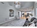 Open-concept living space with plush carpeting and smooth hardwood floors throughout the home at 6520 Fairfield Trce, Suwanee, GA 30024