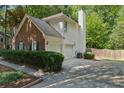 Rear view of home showing garage, siding, and a manicured yard at 6520 Fairfield Trce, Suwanee, GA 30024