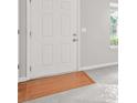 Neutral interior of a home featuring a white door with wood transition at 1890 Owens Trl, Rex, GA 30273