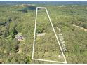 Aerial view of a vast 7.09-acre parcel, offering privacy and surrounded by dense woods at 4120 Grady Smith Rd, Loganville, GA 30052