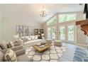Bright living room featuring large windows, a cozy sofa, and stylish decor at 4120 Grady Smith Rd, Loganville, GA 30052