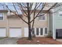 Two-story townhome featuring a garage and door opening to back; tree in front yard at 1731 Pryor Sw Rd # 307, Atlanta, GA 30315
