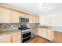 Charming kitchen with stainless steel appliances, granite countertops, mosaic backsplash, and wooden cabinetry at 4140 Riverlook Parkway Se Se Pkwy # 209, Marietta, GA 30067