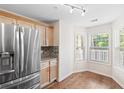 Eat-in kitchen featuring stainless steel refrigerator, granite counters, hardwood floors and plenty of light at 4140 Riverlook Parkway Se Se Pkwy # 209, Marietta, GA 30067