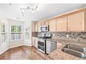 Bright kitchen boasts stainless steel appliances, granite countertops, hardwood floors and ample natural light at 4140 Riverlook Parkway Se Se Pkwy # 209, Marietta, GA 30067