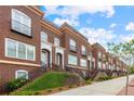 Beautiful brick townhome exteriors ascend from the sidewalk to individual front doors at 5139 Peachtree Road, Chamblee, GA 30341