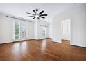 Bright main bedroom features hardwood floors, ceiling fan, and French doors at 5139 Peachtree Road, Chamblee, GA 30341