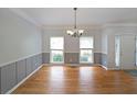 Bright dining room with hardwood floors, wainscoting, and large windows at 5176 Shotwell St, Woodstock, GA 30188
