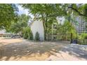 Exterior view of this Habersham of Buckhead residence, featuring mature trees and a private gated entry at 3655 Habersham Ne Rd # 344, Atlanta, GA 30305