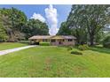 Traditional single-story home with a well-maintained lawn and lush, mature trees at 434 Terrace Sw Dr, Smyrna, GA 30082