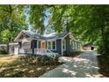 Beautifully renovated home featuring a long driveway and inviting front porch with a fresh coat of paint at 943 Rose Sw Cir, Atlanta, GA 30310