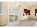 Bright living room featuring a vaulted ceiling, ceiling fan, and sliding glass doors to the backyard at 139 W Oaks Pl, Woodstock, GA 30188
