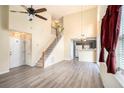 Open-concept living space featuring new flooring, a staircase, and a view of the kitchen at 139 W Oaks Pl, Woodstock, GA 30188