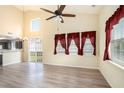 Bright living room featuring a vaulted ceiling, ceiling fan, and sliding glass doors to the outside at 139 W Oaks Pl, Woodstock, GA 30188