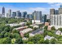 Stunning aerial view showcasing the community's lush green surroundings with the city skyline in the background at 273 12Th Ne St # 111, Atlanta, GA 30309