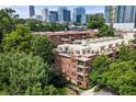 Attractive brick building nestled among mature trees, exuding curb appeal and timeless charm at 273 12Th Ne St # 111, Atlanta, GA 30309