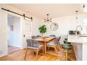 Bright dining room featuring a modern light fixture, table for six and a sliding barn door at 2411 Fair Lane Ln, Decatur, GA 30032
