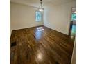 Spacious living room with hardwood flooring and ample natural light, perfect for entertaining at 713 Trickum Valley Dr, Woodstock, GA 30188