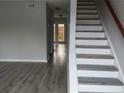 The entryway features new flooring and a staircase with wooden railings at 1818 Ashborough Cir # E, Marietta, GA 30067