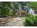 Quaint bungalow-style home with covered porch and mature trees at 1876 Madrona Street Nw St, Atlanta, GA 30318