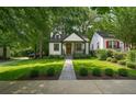 Beautifully landscaped home with manicured lawn and gray stone walkway at 1876 Madrona Street Nw St, Atlanta, GA 30318
