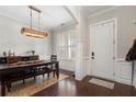 Elegant dining room showcases a modern chandelier, plantation shutters, and wainscoting for a sophisticated touch at 6430 Banbury Se Ct, Mableton, GA 30126