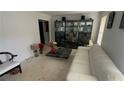 Living room featuring a white sofa, dark display cabinet and a decorative table at 1095 Mitchell Crossing Sw Dr, Atlanta, GA 30331