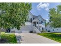 Well-maintained two-story home with a two-car garage, inviting front porch and green lawn at 3153 Morgan Box Ne Ln, Buford, GA 30519