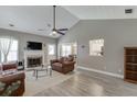 Spacious living room with vaulted ceiling, fireplace, and wood-look floors at 3153 Morgan Box Ne Ln, Buford, GA 30519