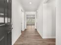 Bright hallway featuring neutral walls, modern baseboards, and beautiful flooring throughout the home at 913 Sundown Pt, Villa Rica, GA 30180