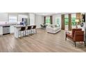 Open-concept living space features modern furniture, wood-look flooring, and lots of natural light at 165 Winner St, Acworth, GA 30102