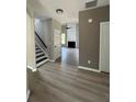Open entryway showcasing modern flooring, a staircase, and a view into the living area with fireplace at 2147 Saint Albans Pl, Buford, GA 30519