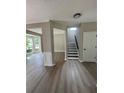 Welcoming entryway featuring sleek floors and access to a staircase, complemented by neutral wall colors at 2147 Saint Albans Pl, Buford, GA 30519