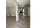 Spacious living area showcasing modern flooring and neutral paint, with open access to other rooms at 2147 Saint Albans Pl, Buford, GA 30519