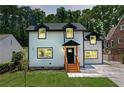 Charming two-story home with white siding, black trim, dormer windows and well-manicured yard at 656 S Elizabeth Nw Pl, Atlanta, GA 30318