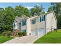 Beautiful home with a two car garage, pretty green shutters, and lush green lawn in a suburban neighborhood at 672 Victorian Cir, Dallas, GA 30157