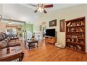 Spacious living room features hardwood floors, vaulted ceiling, built-in shelving, and decorative elements at 672 Victorian Cir, Dallas, GA 30157
