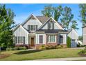 Beautiful home boasts a well-manicured lawn, stylish gray siding, and black trim at 2208 Sage Mountain Sw Ct, Marietta, GA 30064