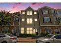 Charming townhome featuring a well-manicured front yard during dusk at 234 Riverstone Commons Cir, Canton, GA 30114