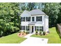 Charming two-story home features a landscaped front yard and classic black and white accents at 5350 Mercedes Dr, Cumming, GA 30041