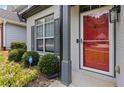 Welcoming front entrance with a vibrant red door, well-kept bushes and green plants at 1269 Gates Se Cir, Atlanta, GA 30316