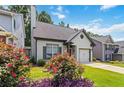 Beautiful front exterior with lush landscaping and a well-maintained lawn under a blue sky at 1269 Gates Se Cir, Atlanta, GA 30316