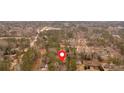 Aerial view of a neighborhood with trees, houses, and roads, marked with a location pin at 4138 Hickory Dr, Powder Springs, GA 30127